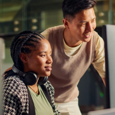 Alt text: Colleagues looking at computer in office