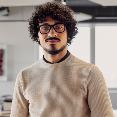 Man with glasses smiling in office